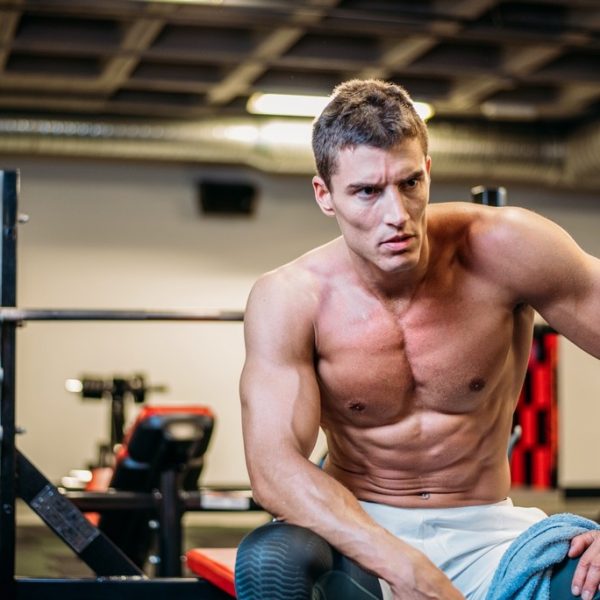 Muscular bodybuilder with towel